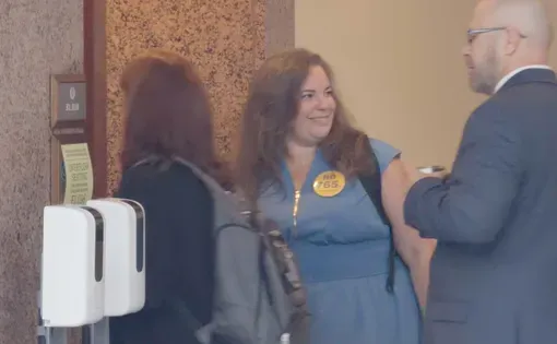 Mia Sarot, founder of the Hill Country Land and Legacy Alliance, speaks with attendees outside a Texas Senate Committee on Business and Commerce hearing on proposed 765-kilovolt transmission lines at the Texas Capitol …