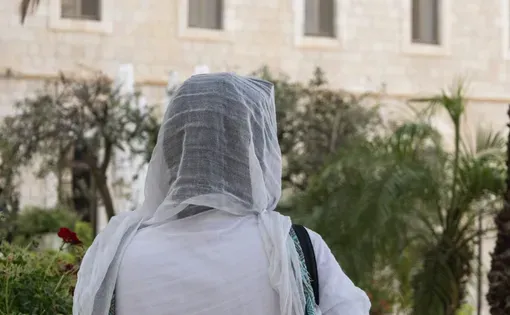 Yordanos, who asked that her last name not be used for fear of deportation, looks out toward the walls of Jerusalem’s Old City, Aug. 14. She and her children are at risk of deportation from Israel. (Theia Chatelle)
