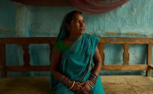 Rajkumari Patel, a community health worker trained to ensure impoverished pregnant women in rural Nepal receive timely prenatal care, poses for a portrait in her home in Gaur, Nepal, on May 20, 2026. (AP Photo/Bram Janssen)