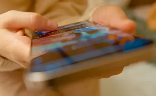 Female hands scroll social media on a smart phone