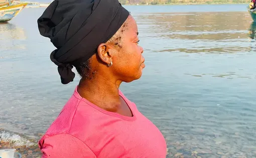 45 year old Martha Bwalya looks out across Lake Tanganyika after failing to secure fish at Ngwenya Landing Site in Mpulungu District, despite having money to buy it.