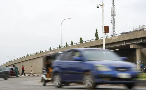 Traffic moves along a road under CCTV surveillance cameras in Abuja, Nigeria. Image by Marvellous Durowaiye.