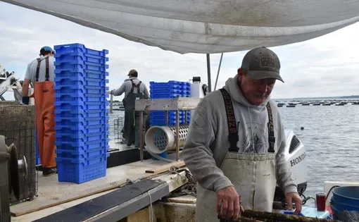 Russ Blank, owner of Rome Point Oyster Co. out of North Kingstown, R.I., on his boat. (Bonnie Phillips/ecoRI News)