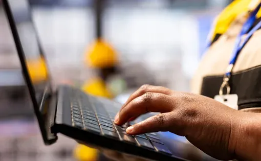 Hand typing on laptop