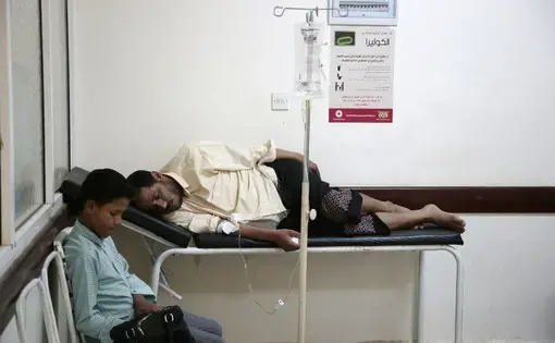 In this July 1, 2017 file photo, a man is treated for suspected cholera infection at a hospital in Sanaa, Yemen. An Associated Press investigation finds that Yemen’s massive cholera epidemic was aggravated by corruption and official intransigence. The investigation has found that both the Iranian-backed Houthis rebels and their main adversary in the war—the U.S.—and Saudi-backed government that controls southern Yemen—impeded efforts by relief groups to stem the epidemic. Image by Hani Mohamed/AP Photo…