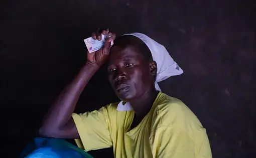 Margaret Arach, 42, watches her children at her home in Pader District, Northern Uganda. She is the sole caretaker of her seven children, two of whom suffer from nodding syndrome. Image by Esther Ruth Mbabazi. Uganda, 2019.