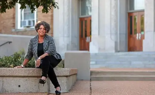 Judy Gladney, 67, poses for a portrait at University City High School on Monday, Sept. 30, 2019, ahead of her 50th high school reunion. Gladney was among the first waves of African American students to integrate the high school. Image by Cristina M. Fletes. United States, 2019.