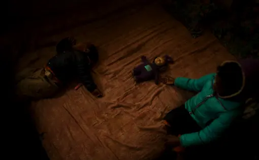 Prudence and Blessing Moyo in the room their family shares in a derelict building, Johannesburg. They fled Zimbabwe after their grandfather, an MDC activist, was burned alive. They have nowhere to run if trouble strikes.