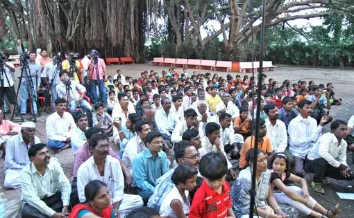 Supporters and news media at an address by Anna Hazare