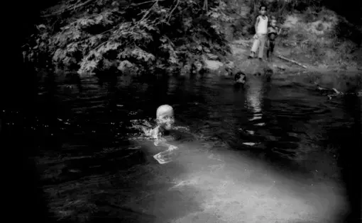 A little Batek boy swims in the river. Image by James Whitlow Delano. Malaysia, 2011.