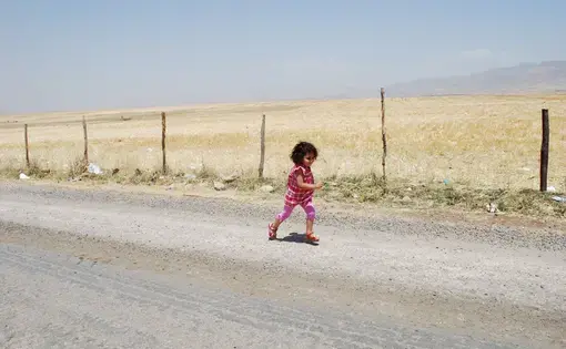 Image by Jenna Krajeski. Southeastern Turkey, 2012 Media file: GirlRunningSilopi.JPG
