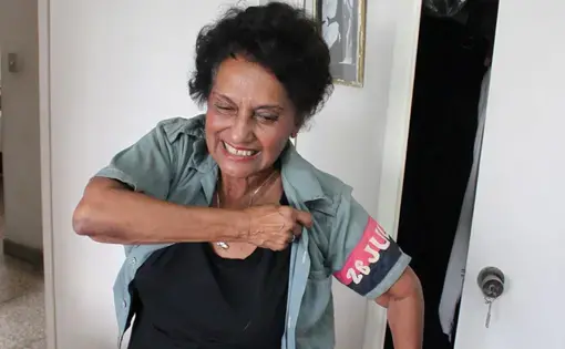 Marta Rojas dons a 51-year-old blouse from Cuba's July 26 Movement.