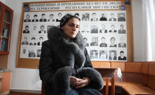 Dibikhan Pugoyeva, 39, in the office of the Mashr human rights group in Karabulak, Ingushetia, Russia.The board behind her shows pictures of people abducted in Ingushetia by security forces. Her son, Magomed Gorchkhanov, 17, was allegedly kidnapped in November 2010 and later found dead. Image: Tom Parfitt, Russia, February 2011.