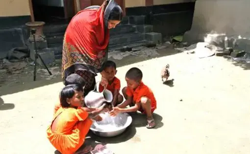 Children wash hands at a child development center in Monohardi, Bangladesh. The centers are called "anchals," from the end piece of a sari mothers use to cover and carry their children (Photo by Jon Sawyer).