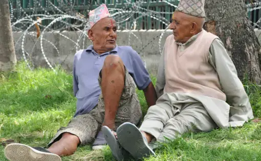 Two elderly men sit under a shade in Kathmandu discussing the country's politics. Nepal is holding elections to select a new prime minister for the ninth time in the last two months. Image by Anup Kaphle. Nepal, 2010.