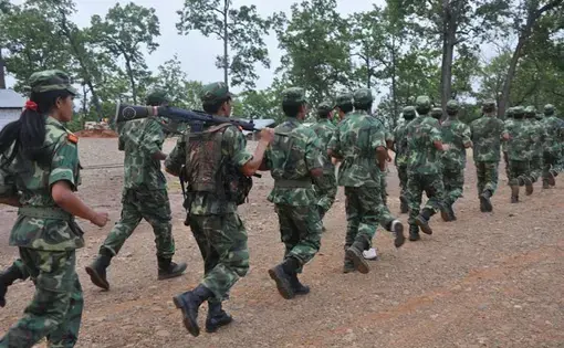 Former Maoist combatants train inside their cantonment in western Nepal. The Indian government has accused Nepali Maoist rebels of providing military and ideological training to hundreds of Indian Maoists inside Nepalese territory.  Image by Anup Kaphle, Nepal, 2010.