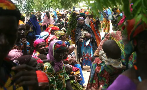 Women line up so their children can be measured, weighed and treated for malnourishment at a World Vision health clinic near Dakoro in east Niger. Image by Ruth Moon. Niger, 2010.