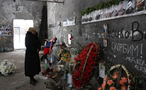 Svetlana Tsgoyeva, 69, in the ruins of the sports hall where her granddaughter, Zalina Albegova, nine, died along with hundreds of other hostages during the Beslan school siege in September 2004. Image by Tom Parfitt. Russia, 2011.