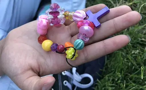 “Each bead means something,” Adrianna says of the bracelet she made me with her mom. “This one,” she says, pointing to the shiniest pink bead, “is supposed to be how much love she has for us because it is so bright." Image by Jaime Joyce for TIME Edge. California, 2018.