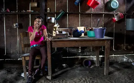 Candelaria López, 15, at home in Yalambojoch, stays at home to help raise her siblings. She no longer goes to school because her family can’t afford to pay the $60 school fee. Image by Simone Dalmasso / The Arizona Daily Star. Guatemala, 2019.