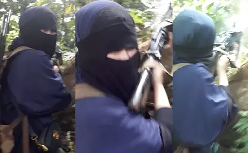 Cici Rezky Fantasy Rullie, said to be around 18, is believed to be the daughter of the Indonesian couple who bombed Jolo Cathedral in January 2019. Cici is seen here engaging in a shootout with the military. Image courtesy of Rappler-sourced video screengrab. Philippines, 2019.