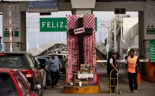 A cross with the pink sign “Ni Una Más” or “Not One More” sits at the Paso del Norte International Bridge, which connects Juárez and El Paso, Texas. “Ciudad Juárez has been a very resilient city battered by gender violence,” says Verónica Corchado, director of the Municipal Institute of Women in Juárez. “From 1993 — when they started registering the cases — until today, around 1,700 women have been murdered as a result of gender violence.” Local academics and activists have helped compile this data. Image…