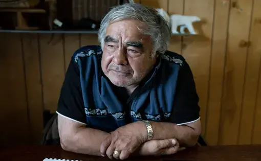 Robert Thompson, Kaktovik polar bear guide, sitting at the table. Image by Nick Mott. United States, 2019.