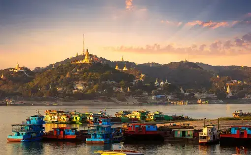 Cargo boats on the Irrawaddy River in Mandalay, Myanmar. Image by Doug Bock Clark. Myanmar, 2018.