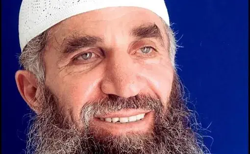 Guantánamo prisoner Abd al Hadi al Iraqi, who says his true name is Nashwan al Tamir, poses for the International Red Cross in a 2014 photo taken for his family. Image provided by Hadi's attorneys. 2014.