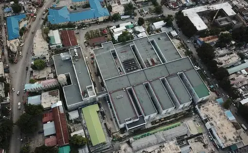 Aerial view of the new State University of Haiti Hospital in Port-au-Prince. The sprawling new hospital campus was one of the first projects approved for Haiti’s reconstruction after the Jan., 12, 2010 earthquake. A decade later, the 534-bed teaching hospital has yet to open its doors to a single patient. Image by Jean Marc Hervé Abélard / The Miami Herald. Haiti, 2019.