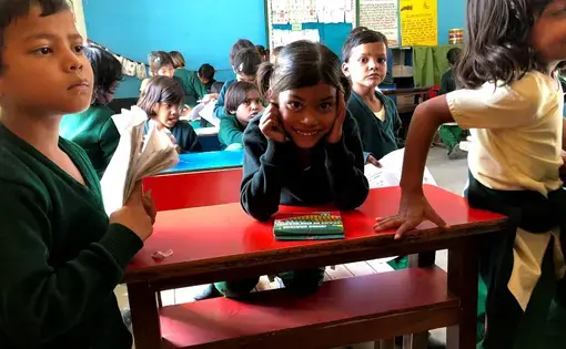 A student smiles during a school day at Pardada Pardadi. Image by Annalisa Merelli. India, 2018.