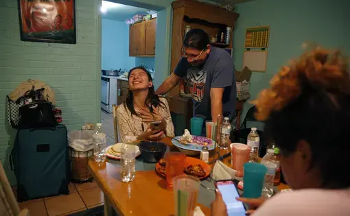 Alexa and Susana laughing at table