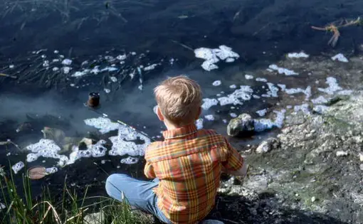 In 1969, a boy fishes in polluted Florida waters. Image from the State Archives of Florida. United States, 1969.