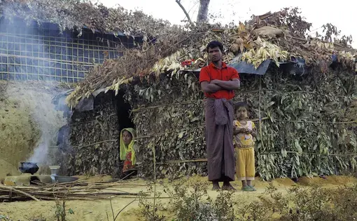 A family with their newly constructed shelter outside Balukhali Refugee Camp. Image by Doug Bock Clark. Bangladesh, 2017.