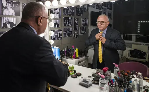 Pavel Lobkov adjusting his tie in front of a mirror. Image by Misha Friedman. Russia, 2018.