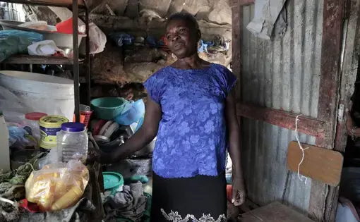 Manette Francois, 58, says that before the Jan. 12, 2010, earthquake she had an easier life than today. She lives in a tent city, Teren Toto, in Delmas, in a tin shack that doubles as living quarters and neighborhood grocery store. Image by Jose A. Iglesias. Haiti, 2019.
