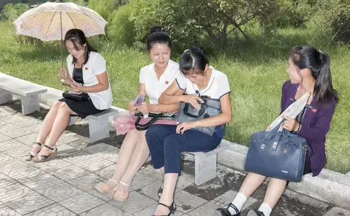 Women along a street in Pyongyang. Image by Max Pinckers/The New Yorker. North Korea, 2017.