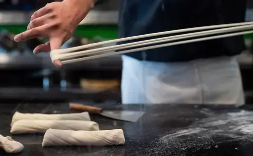 Tony Mao makes noodles at Everyday Noodles in Squirrel Hill. Image by Stephanie Chambers. United States, 2018.