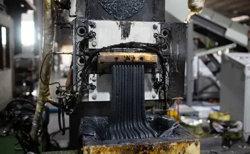 Molten plastic exits an extruder at the YB Enterprises recycling factory in Padang Serai, Malaysia. Health and environmental problems near such factories have sparked anger and opposition in local communities. Image by Sebastian Meyer. Malaysia, 2020.