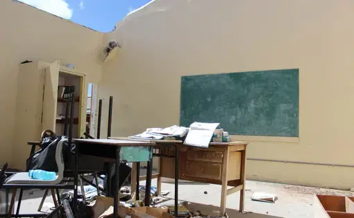Three months after Hurricane Irma, Barbuda's lone primary school in the island capital Codrington remains roofless. An estimated 90 percent of properties were damaged in Barbuda when the Caribbean island was hit by Irma on Sept, 6, 2017. Image by Gregory Scruggs. Barbuda, 2017.