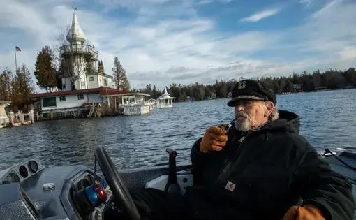 Kenneth "Captain Ken" Kloster Sr. pilots his boat to his home on Dollar Island in Les Cheneaux Islands on Lake Huron in the Upper Peninsula of Michigan on Nov. 23, 2019. He bought the island in 1981 right before record setting high water levels of 1986. Image by Zbigniew Bzdak / Chicago Tribune. United States, 2020.