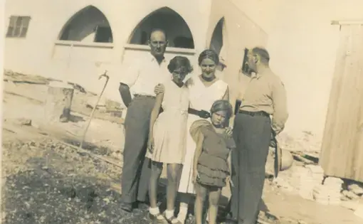 Shula Lavyel and her younger sister, Avivit, with their father (right) and his two siblings, in front of their house in Haifa being built. Image courtesy of Shula Lavyel. British Mandate of Palestine, 1935.