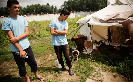 Hashmat (L) and Faiz outside their living quarters in June. Image by Zack Beauchamp for Vox. Hungary, 2018.