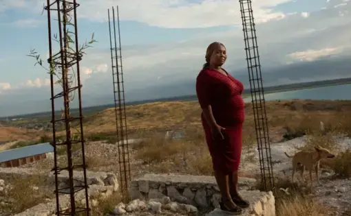 Carmen Cean, a.k.a. "Madame Roy," poses for a photo on a foundation near her home on a hilltop in the Village de Pecheur neighborhood of greater Canaan. Image by Allison Shelley. Haiti, 2019. Carmen Cean, a.k.a. "Madame Roy," poses for a photo on a foundation near her home on a hilltop in the Village de Pecheur neighborhood of greater Canaan. Image by Allison Shelley. Haiti, 2019.