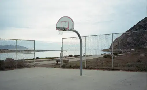 View of Morro Bay, California, from the basketball court. In California, land seized from the Chumash, Yokuts, and Kitanemuk tribes by unratified treaty in 1851 became the property of the University of California and is now home to the Directors Guild of America. Image by Kalen Goodluck / High Country News. United States, 2020.