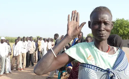 Nyayouk Duok making her intentions clear at the polling center. The open hand was the ballot symbol for “separation” from Sudan, which would create the world’s newest nation. Pictorial symbols were placed on the ballot in a country where 85 percent of the population cannot read or write. Image by Fred de Sam Lazaro. Sudan, 2011.