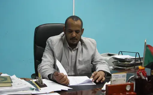 Mohammed Elhag Hamed, a physician at Omdurman Teaching Hospital, looks over some of the files documenting corruption under the former regime in Omdurman, Sudan, on Nov. 3. Image by Rebecca Hamilton/ Foreign Policy. Sudan, 2019.