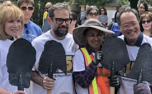 Artist Pedro Reyes and cellist Yo-Yo Ma prepare to plant trees with community members at North Lawndale's 150-year anniversary celebration, presenting Reyes' 2017 work "Palas por pistolas" (Guns into Shovels). Image by Terrance Patterson. United States, 2019.