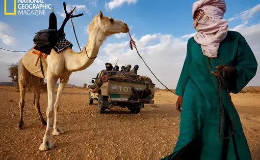 Tuareg militiamen encounter one of their nomadic kinsmen.