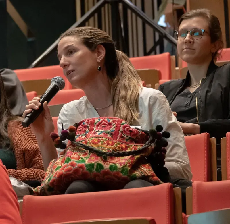 an audience member asks a question at a film screening